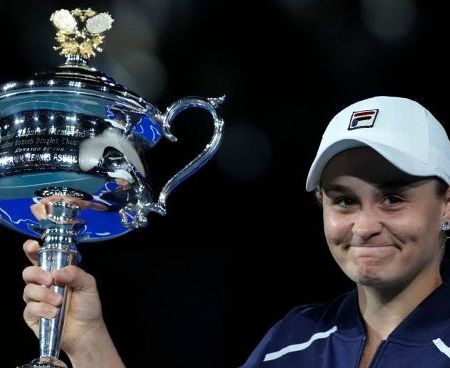 Ash Barty with Australian Open trophy, 29 Jan 2022, photo by Simon Baker, AP