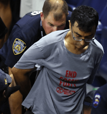 protester at US Open, less cropped, sep 2023, photo by Al Bello